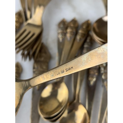 174 - 40 PIECE STAR OF SIAM BRASS CUTLERY WITH BUDHHA HANDLES