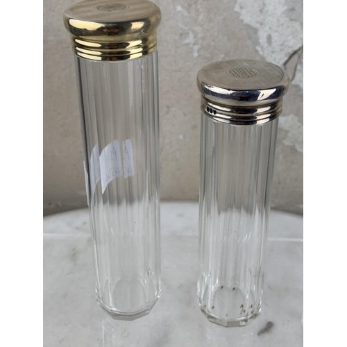 205 - A PAIR OF TALL SILVER TOPPED BOTTLES