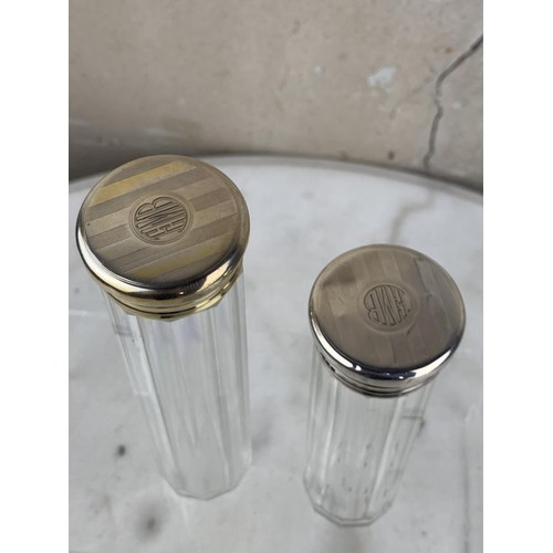 205 - A PAIR OF TALL SILVER TOPPED BOTTLES