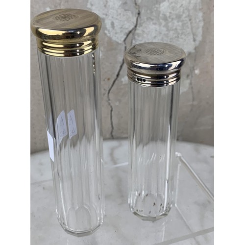 205 - A PAIR OF TALL SILVER TOPPED BOTTLES