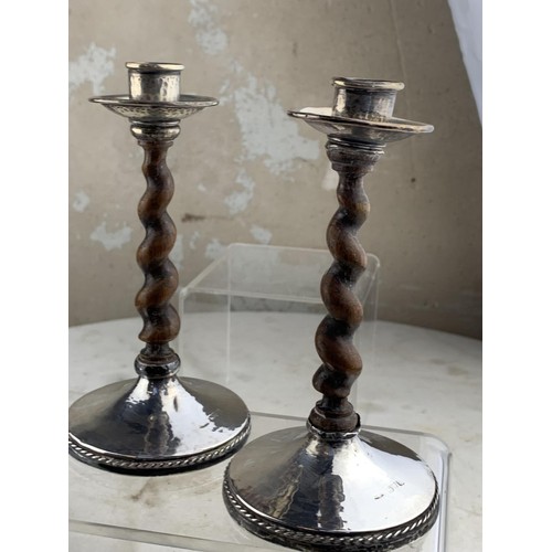 210 - A PAIR OF CHESTER SILVER MOUNTED CANDLE STICKS WITH AN ANTIQUE WOODEN TWIST STEM