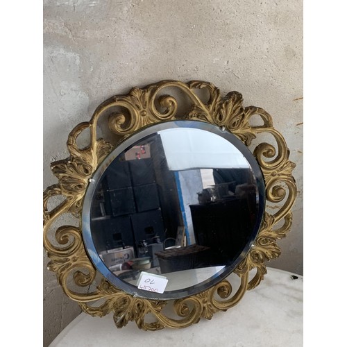 352 - A ROUND BEVELLED EDGED MIRROR IN ORNATE GILT FRAME BY ATSONFA 14