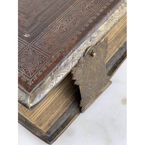 388 - A LARGE ANTIQUE ILLUSTRATED BIBLE WITH ORNATE CHASED LEATHER COVER AND BRASS BINDING