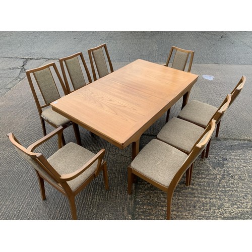 397 - A NATHAN EXTENDING DINNG TABLE AND 8 CHAIRS