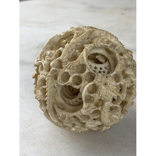 578 - AN ORIENTAL PUZZLE BALL MADE FROM BONE DEPICTING DARGONS