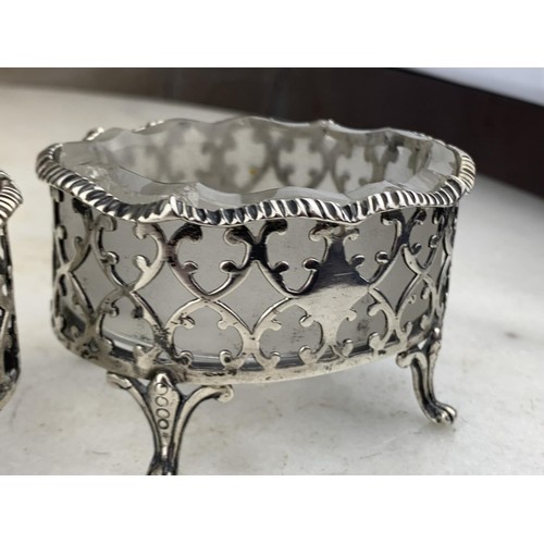 591 - A PAIR OF LARGE ORNATE LONDON (1874) SILVER SALT STANDS WITH ANTIQUE FROSTED GLASS LINERS (SILVER WE... 