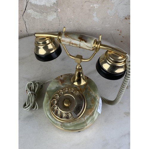 702 - AN ONYX AND BRASS FINISHED TELEPHONE