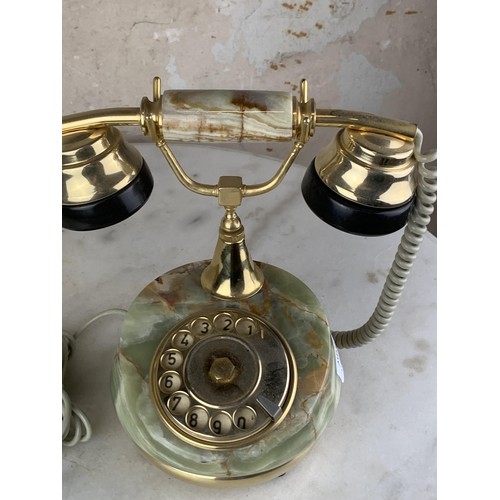 702 - AN ONYX AND BRASS FINISHED TELEPHONE