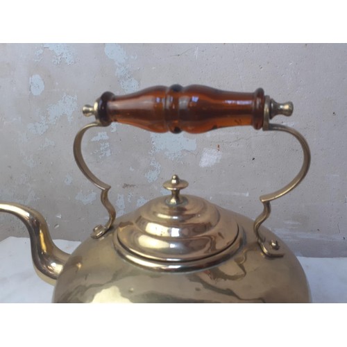 54 - A BRASS KETTLE WITH AN AMBER HANDLE