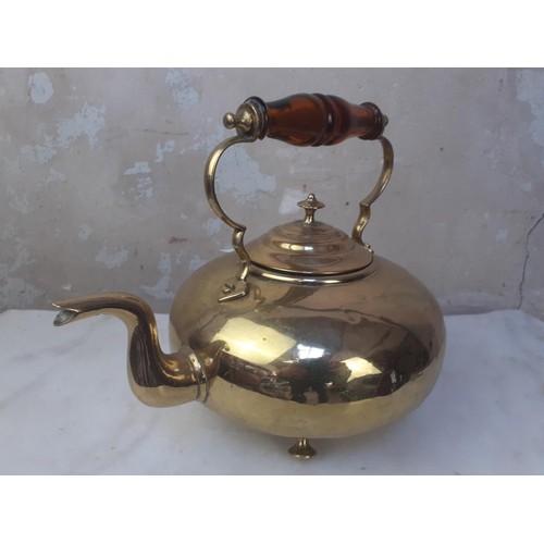 54 - A BRASS KETTLE WITH AN AMBER HANDLE