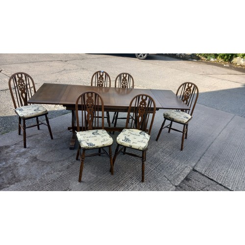 11 - A DRAW LEAF OAK TABLE 2 CARVERS AND 4 CHAIRS