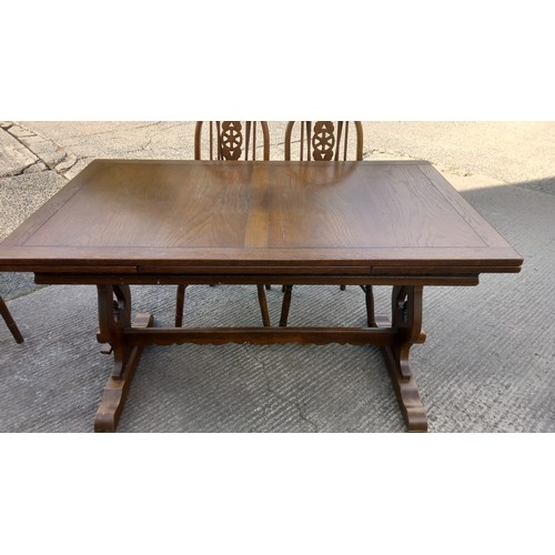 11 - A DRAW LEAF OAK TABLE 2 CARVERS AND 4 CHAIRS