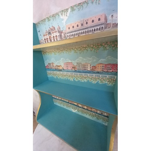 168 - A BLUE & GILT BOOKSHELVES WITH A VINETAIN SCENE'S