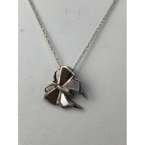 238 - A SILVER AND M.O.P BUTTERFLY PENDANT ON FANCY SILVER CHAIN