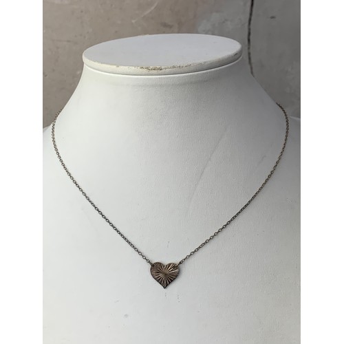 276 - A VINTAGE HEART SHAPED PENDANT ON SILVER CHAIN