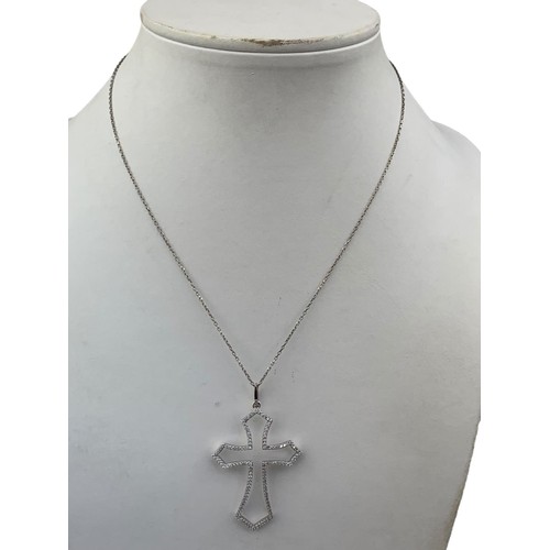 580 - A SILVER CROSS AND SILVER CHAIN CROSS IS ENCRUSTED WITH DIAMANTE STONES