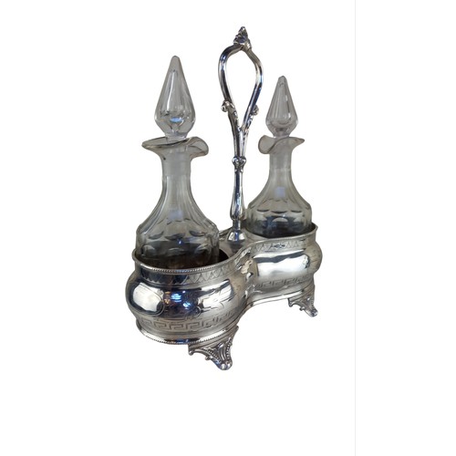 723 - A PAIR OF OIL/VINEGAR DECANTERS IN EPNS CARRIER