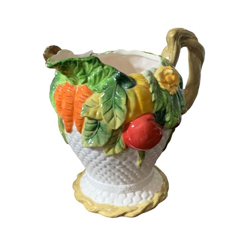 104 - A HAND PAINTED JUG ADORNED WITH FRUIT