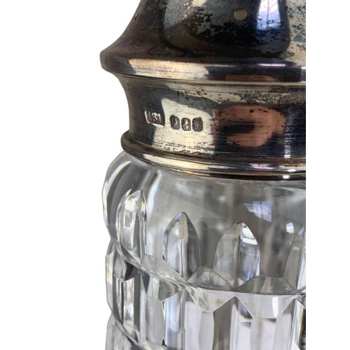 302 - A CUT GLASS SUGAR SHAKER WITH HALLMARKED SILVER TOP 8.5