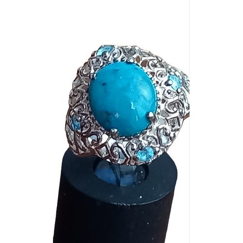 205 - AN ORNATE OPENWOK SILVER TURQUOSE AND TOPAZ RING