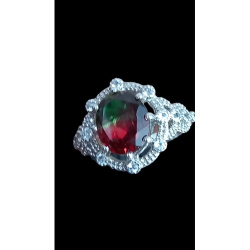 273 - AN ORNATE SILVER MYSTIC TOPAZ RING