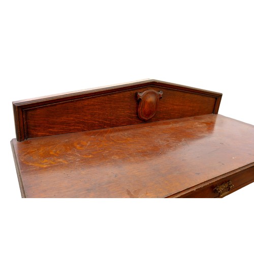 125A - AN ANTIQUE OAK SINGLE DRAWER CONSO; TABLE WITH BRASS STICKSTAND RAIL THE MOULDED GALLERY BACK HAS A ... 