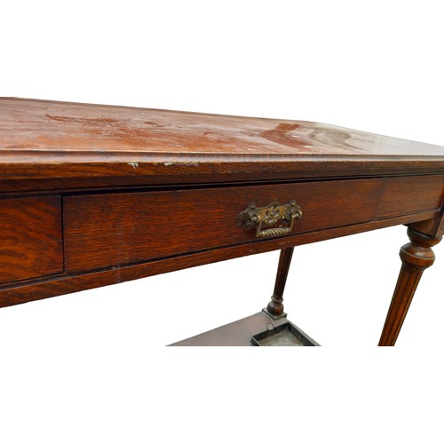 125A - AN ANTIQUE OAK SINGLE DRAWER CONSO; TABLE WITH BRASS STICKSTAND RAIL THE MOULDED GALLERY BACK HAS A ... 