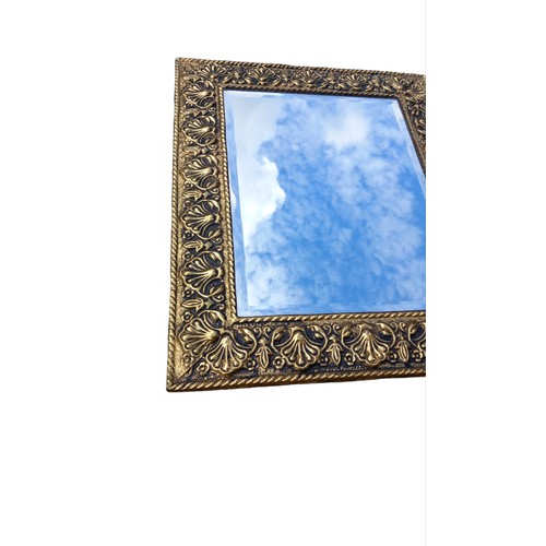 115 - AN ORNATE GILT FRAMED BEVELL EDGE MIRROR 18X22