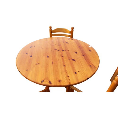 7 - A CIRCULAR PINE TABLE & 3 CHAIRS