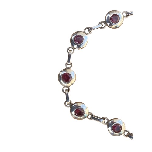 246 - A HEAVY SILVER BRACELET SET WITH RUBY STYLE STONES (1 STONE MISSING)