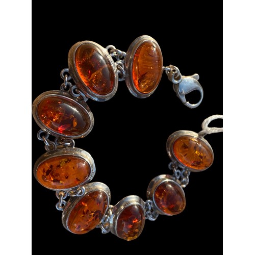 262 - A SILVER AND AMBER BRACELET