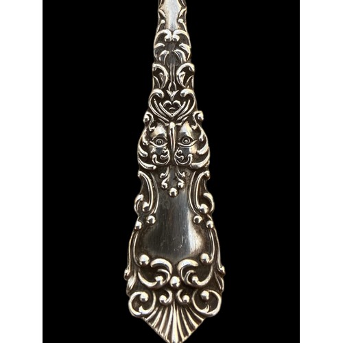 264 - A SILVER HANDLED BUTTON AND AN ORNATE SILVER PASTRY FORK