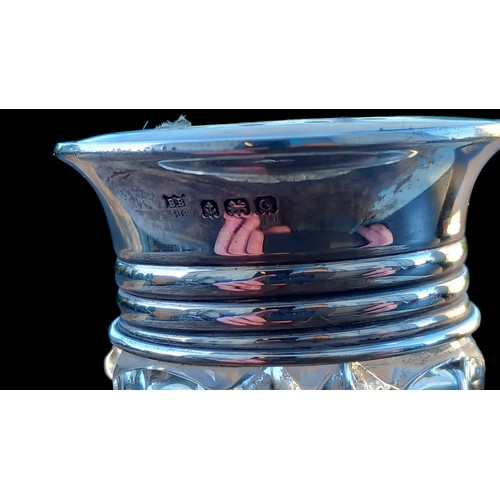 197 - A CUT GLASS SIFTER WITH A SILVER AND M.O.P TOP