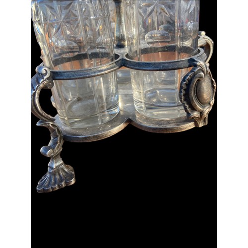 376 - AN ANTIQUE CUT GLASS AND ETCHED CRUET SET IN A PLATED HOLDER