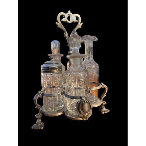 376 - AN ANTIQUE CUT GLASS AND ETCHED CRUET SET IN A PLATED HOLDER