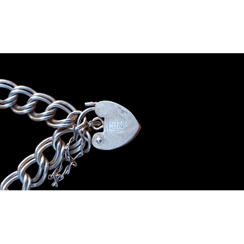 561 - A STERLING SILVER BRACELET WITH PADLOCK 12G