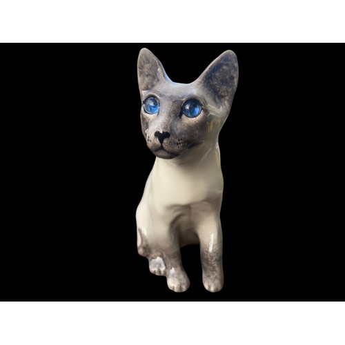 493 - A SIGNED POTTERY CAT WITH BLUE GLASS EYES 13