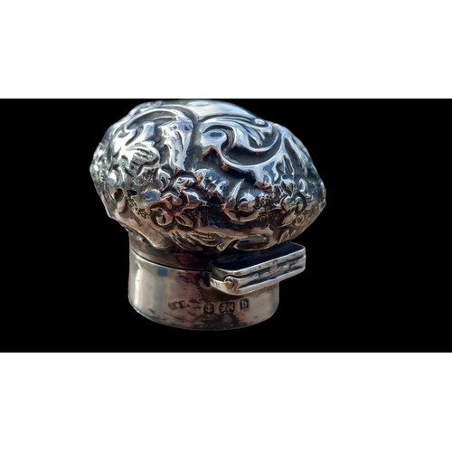 596 - AN ANTIQUE CUT GLASS PERFUME BOTTLE WITH GLASS STOPPER AND EMBOSSED BIRMINGHAM SILVER TOP