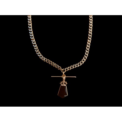 648 - A HEAVY 9CT GOLD CURB LINK CHAIN WITH A T.BAR WITH A DOUBLE SIDED PENDANT SET WITH MOTHER OF PEARL &... 