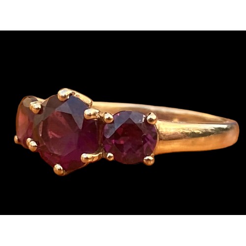 663 - A 9CT GOLD RING SET WITH 3 RUBY STYLE STONES WITH DIAMOND CHIPS TO THE OUTSIDE OF THE SETTING