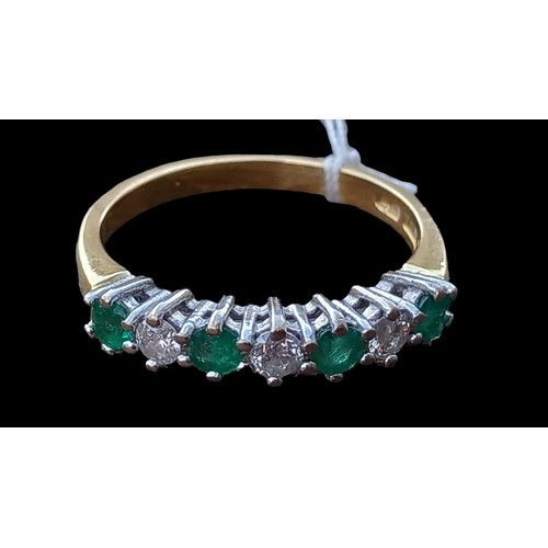 672 - AN 18ct  EMERALD AND DIAMOND ETERNITY RING -4 EMERALDS AND 3 DIAMODS IN 18ct WHITE GOLD CLAW SETTING