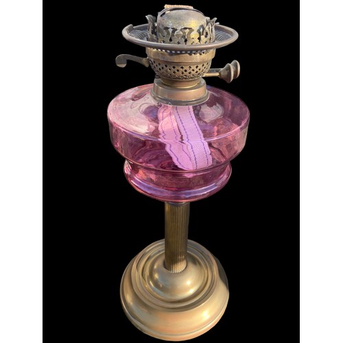 716 - A VICTORIAN RUBY BOLWED OIL LAMP WITH A BRASS BASE