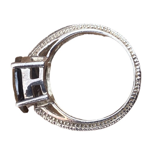 775 - A DESIGNER ORNATE BAND SILVER RING WITH DARK TOPAZ STONE WITH A GEM SET SHOULDER