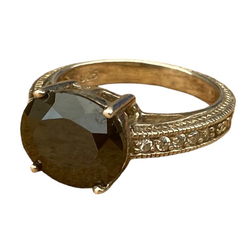 775 - A DESIGNER ORNATE BAND SILVER RING WITH DARK TOPAZ STONE WITH A GEM SET SHOULDER