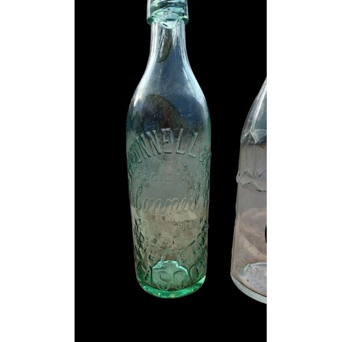 812 - 2 VINTAGE GLASS BOTTLES H.CONNELL & CO & COCHRANE LTD