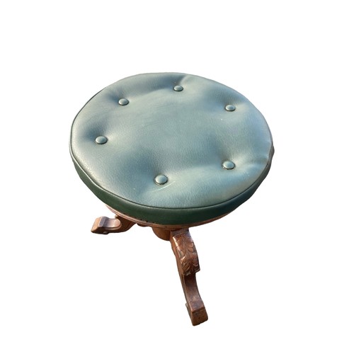 700A - ANTIQUE REVOLVING STOOL WITH A GREEN LEATHER BUTTON TOP AND CARVED TRI POD BASE