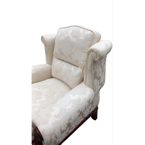 142 - A PATTERNED WINGBACK ARMCHAIR