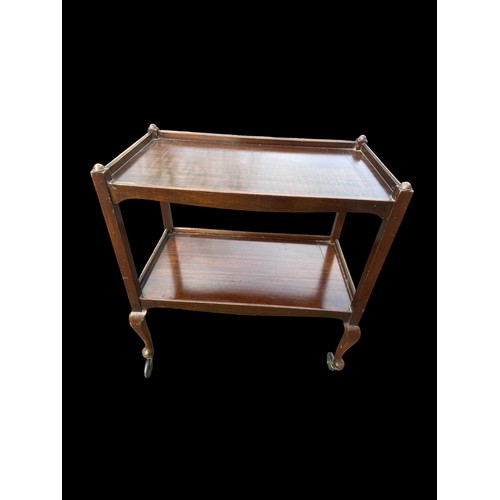 19 - A SHAPED MAHOGANY TROLLEY