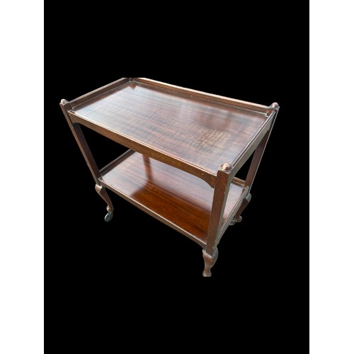 19 - A SHAPED MAHOGANY TROLLEY