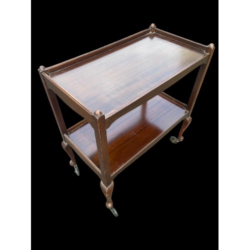 19 - A SHAPED MAHOGANY TROLLEY